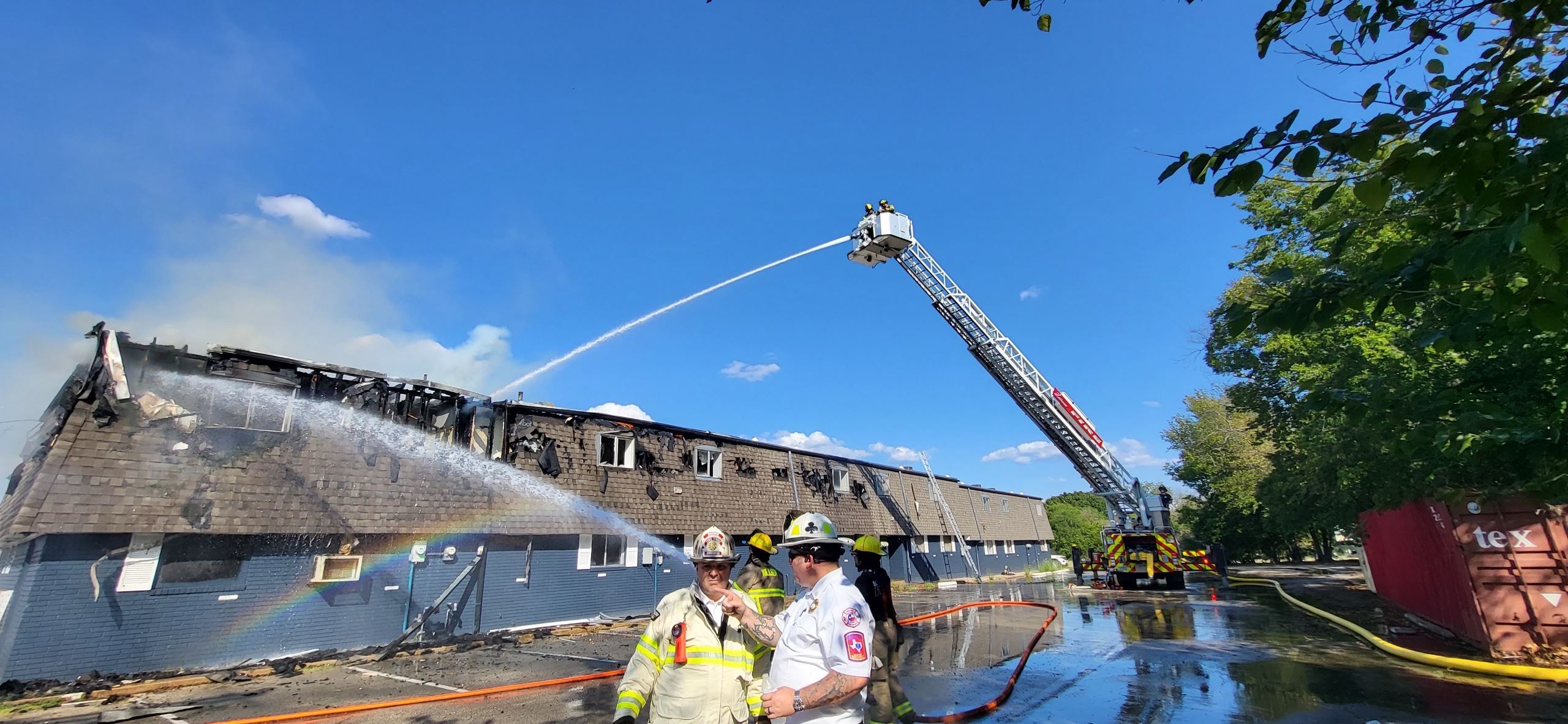 Fire ladder truck extinguishing fire at Adams Avenue apartment complex fire