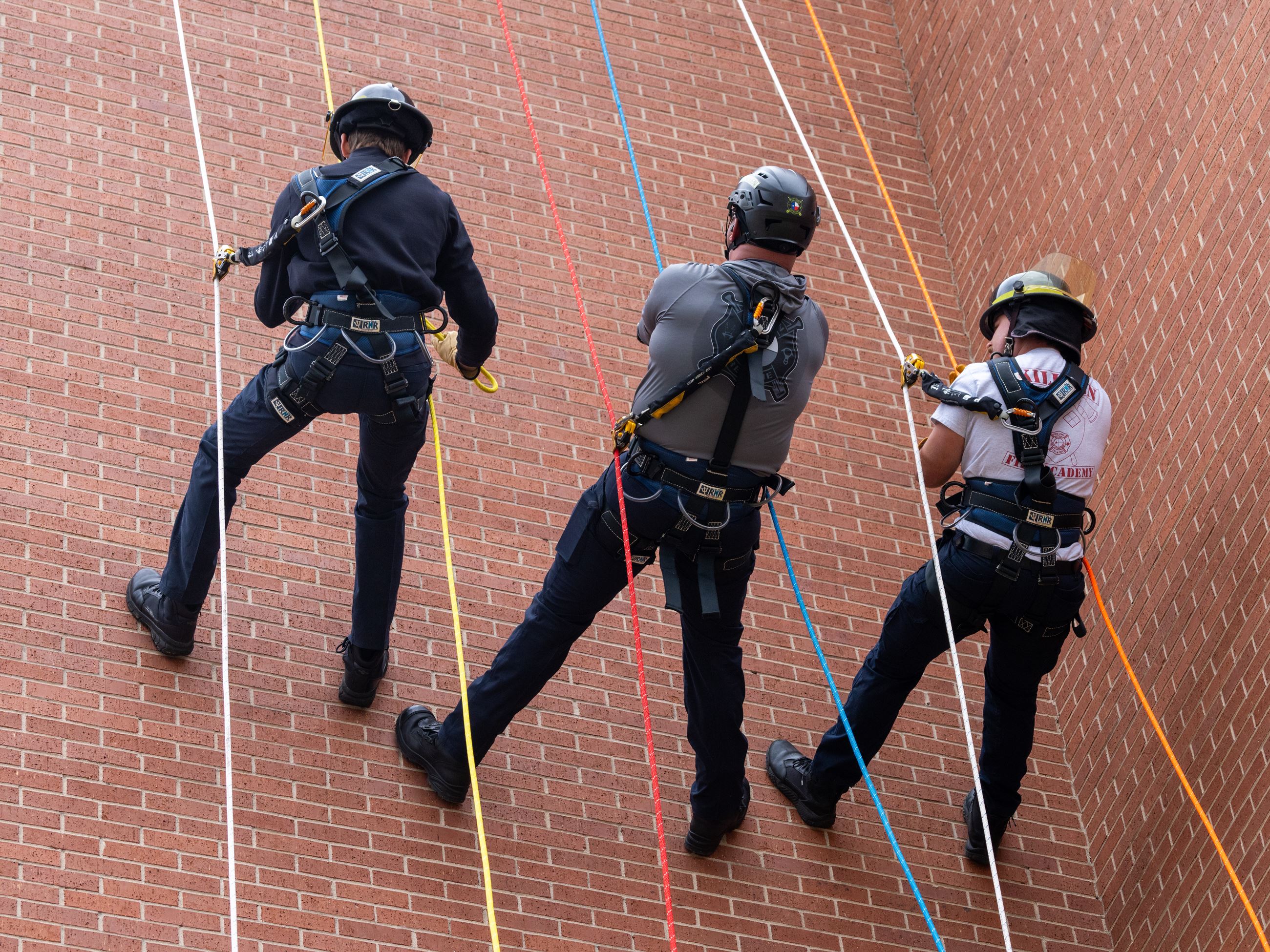 Firefighters climbing wall with rope (JPG)